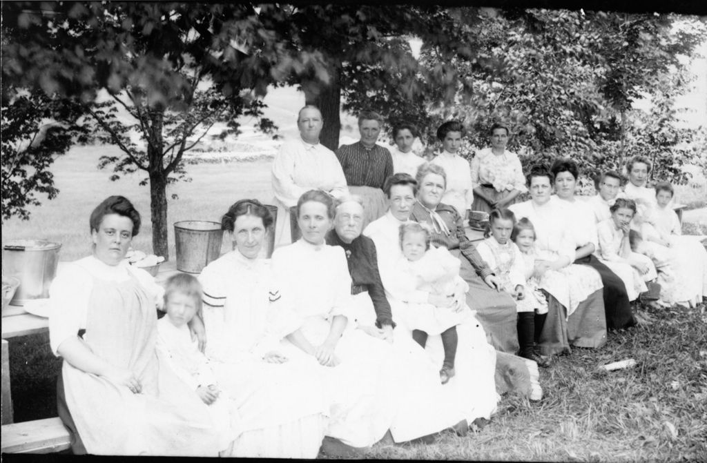 Miniature of Women and young girls sitting at picnic tables.