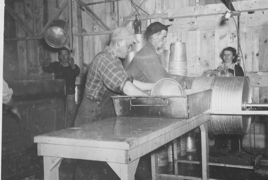 Miniature of Workers washing collection buckets inside sugar house