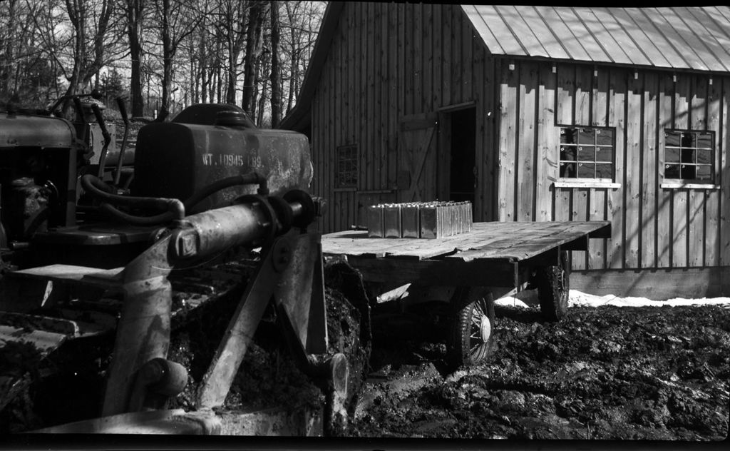 Miniature of Tractor hauling maple syrup in front of sugar house