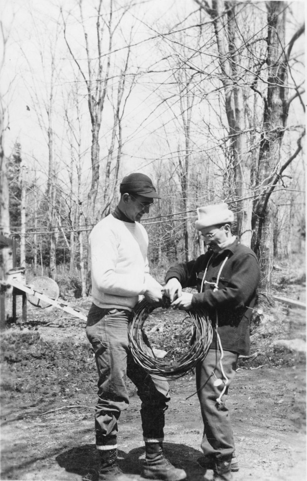 Miniature of Workers rolling up tubing