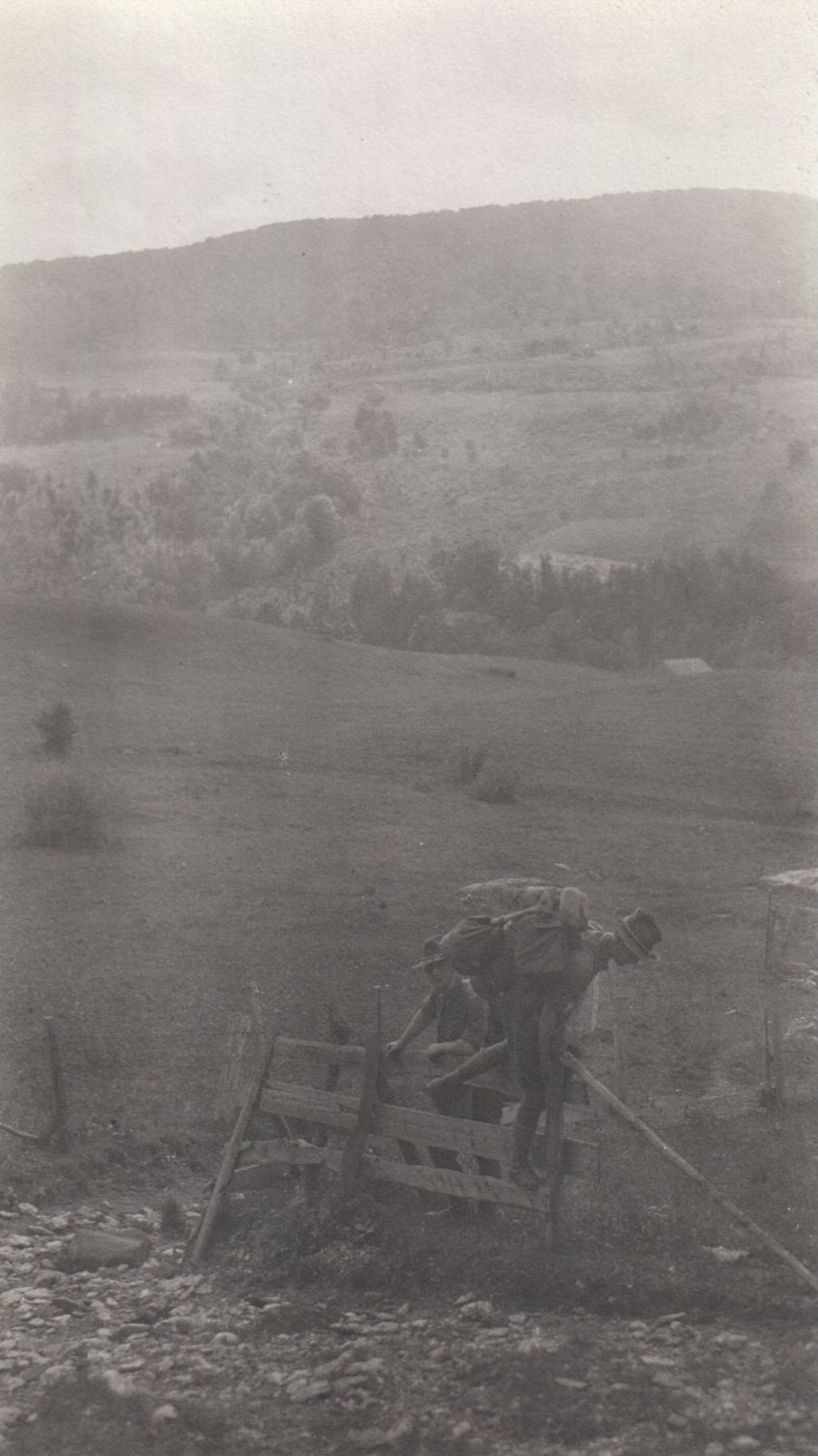 Miniature of Men climbing a fence