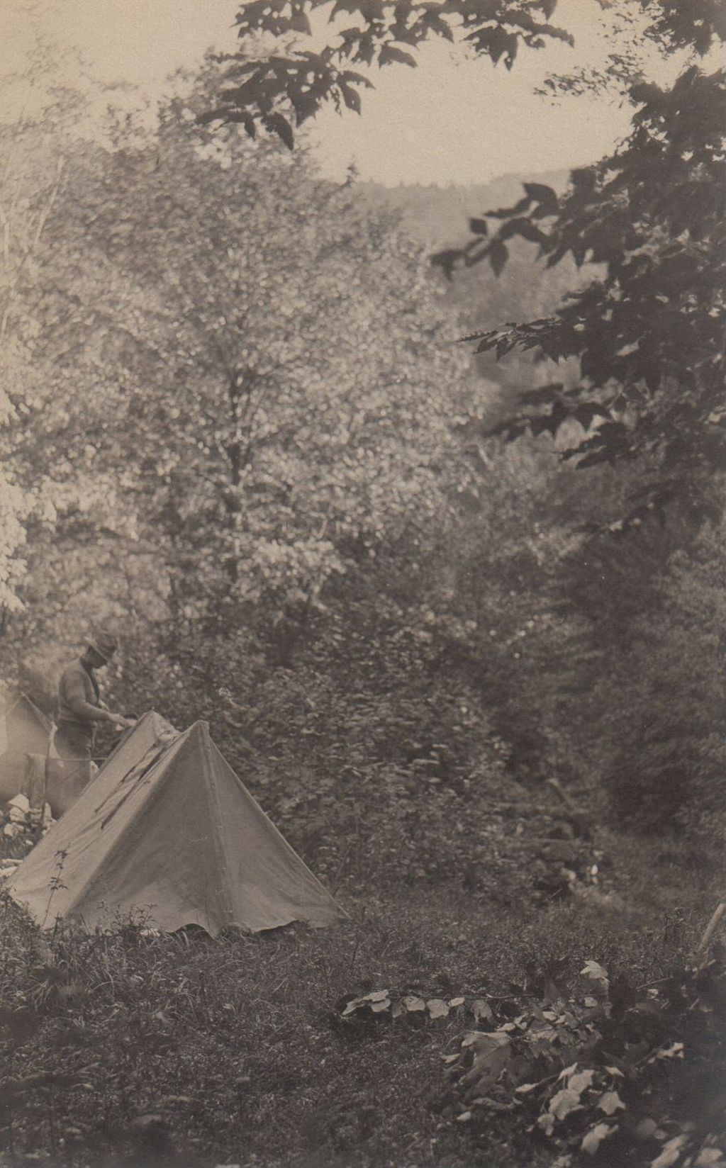 Miniature of Man with tent in a clearing