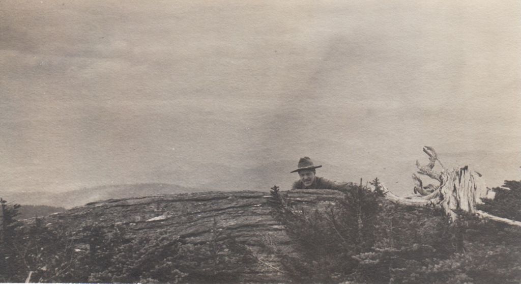 Miniature of Man behind ledge and mountain view