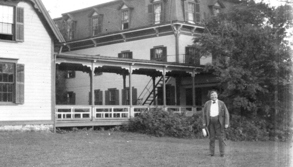 Miniature of Man in front of large building