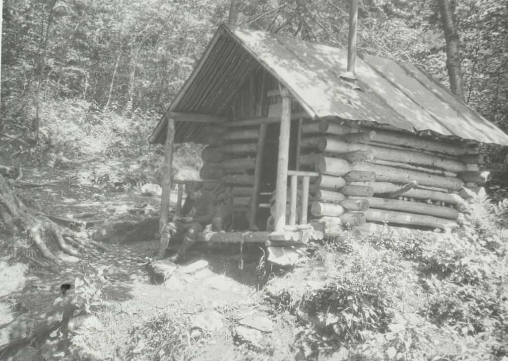 Miniature of Man at small log cabin