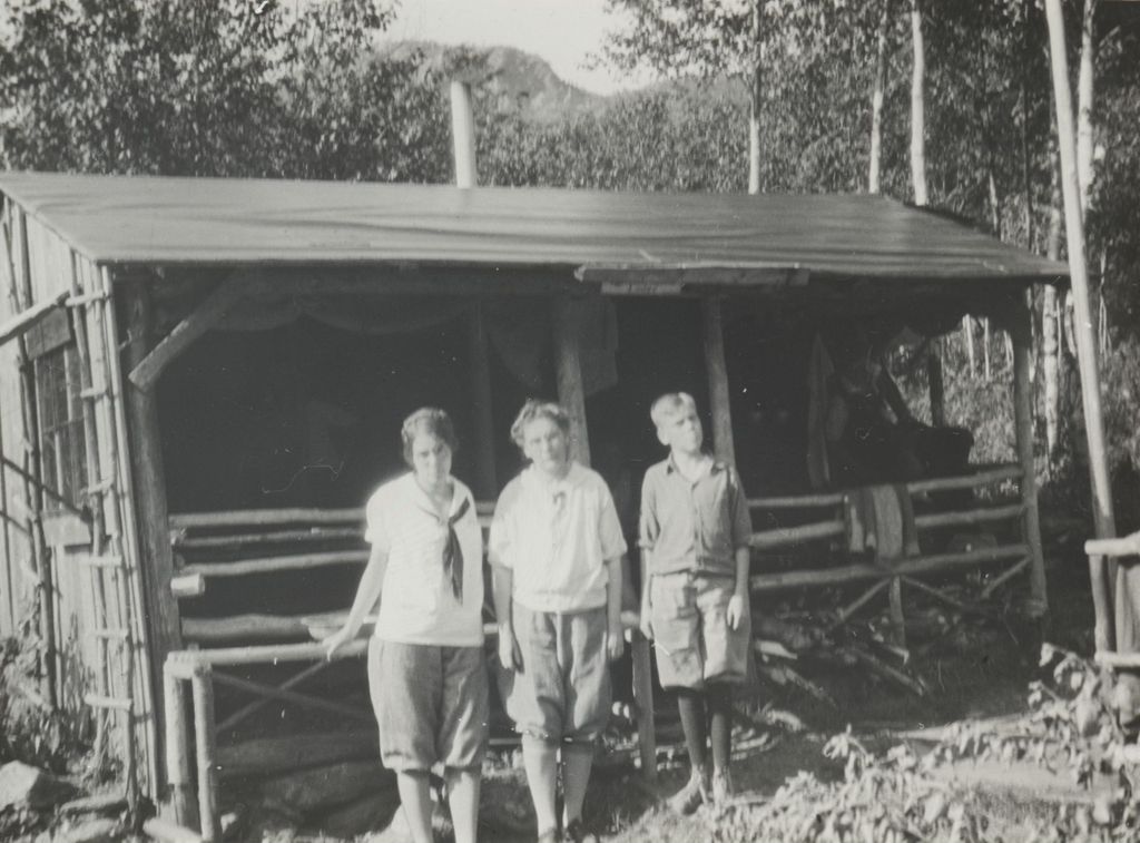 Miniature of Three young people in front of a lodge