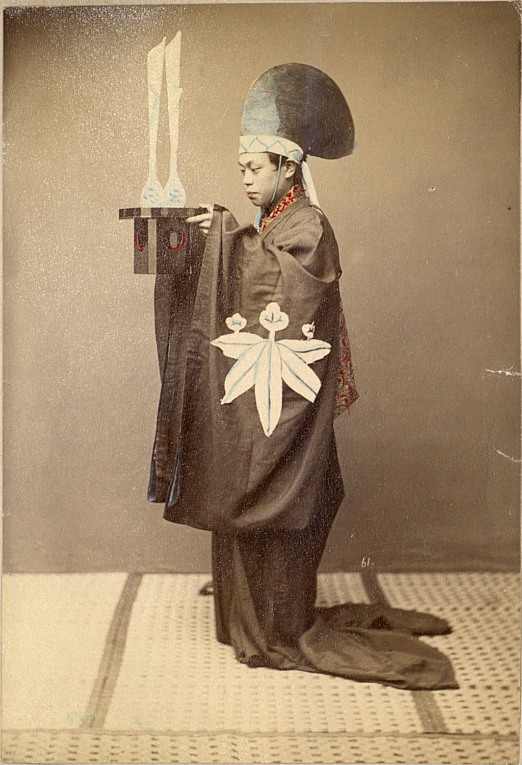Miniature of Priest holding a religious accoutrement