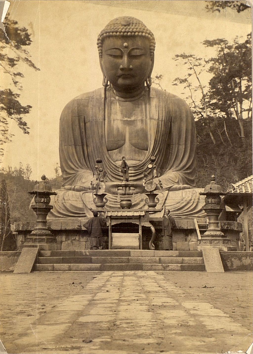 Miniature of Monks in front of a large statue of Buddha