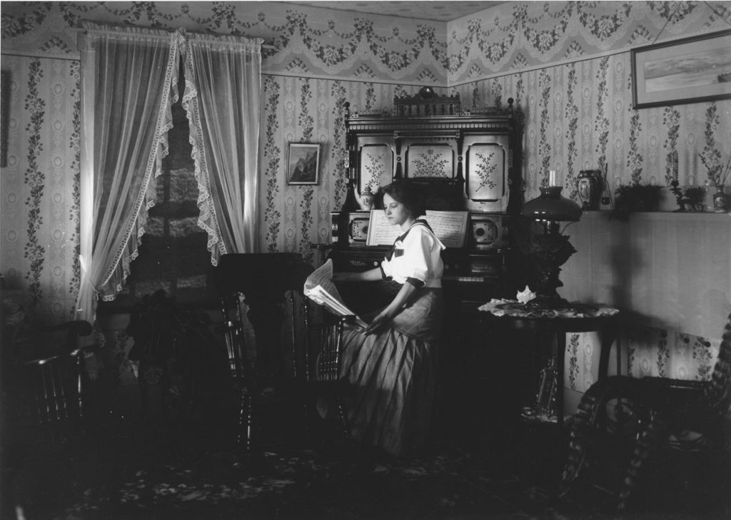 Miniature of Mrs. Eddy's house interior with young woman at piano